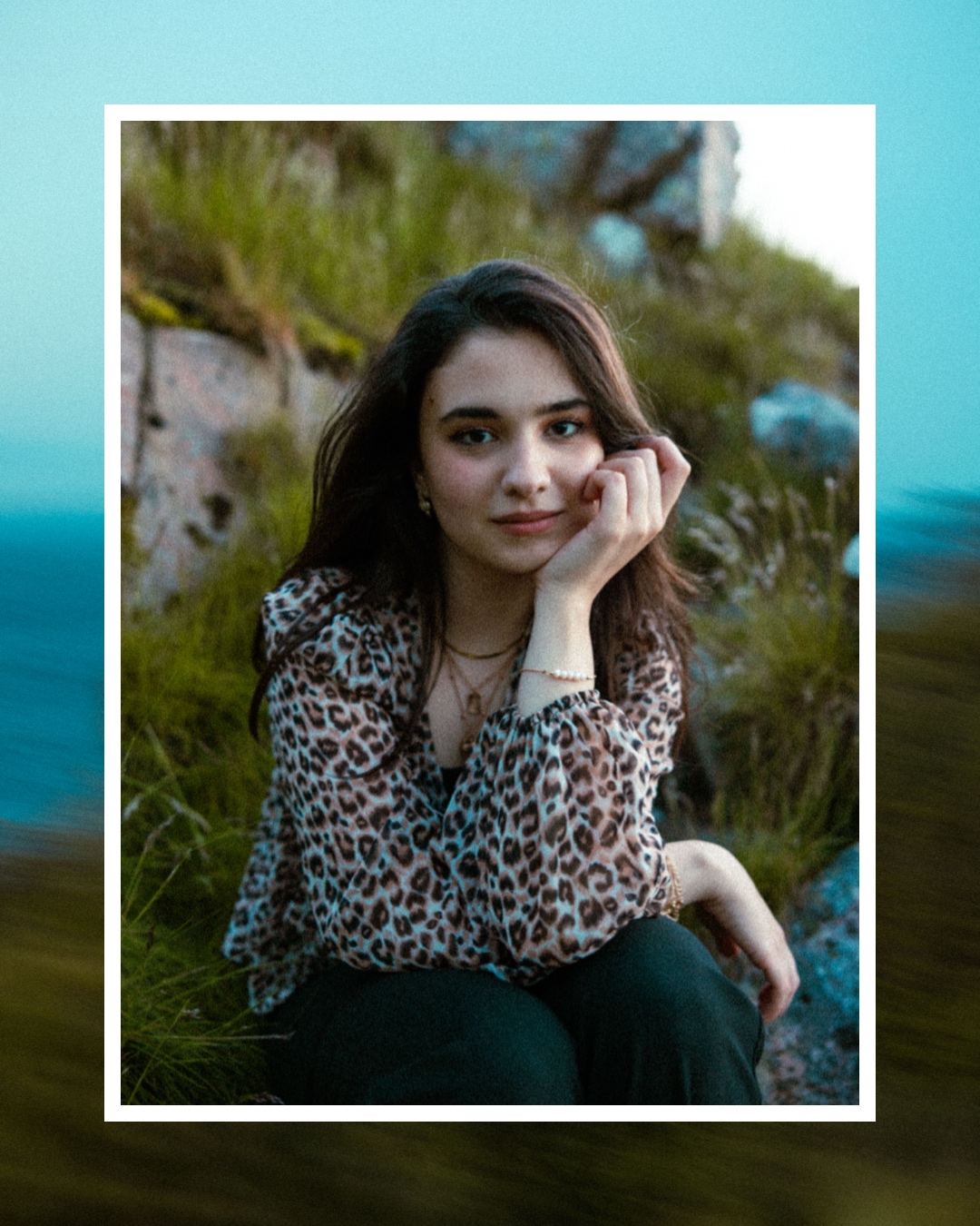 Lana Oudeh seated outdoors near the coast